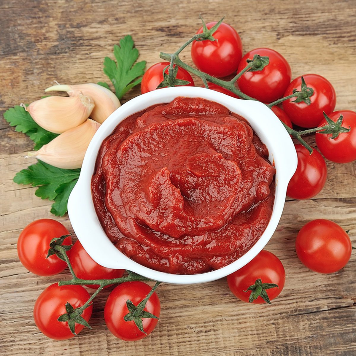 Tomatoes paste with spices and greens on wooden tables; Shutterstock ID 130085642; Job (TFH, TOH, RD, BNB, CWM, CM): Taste of Home