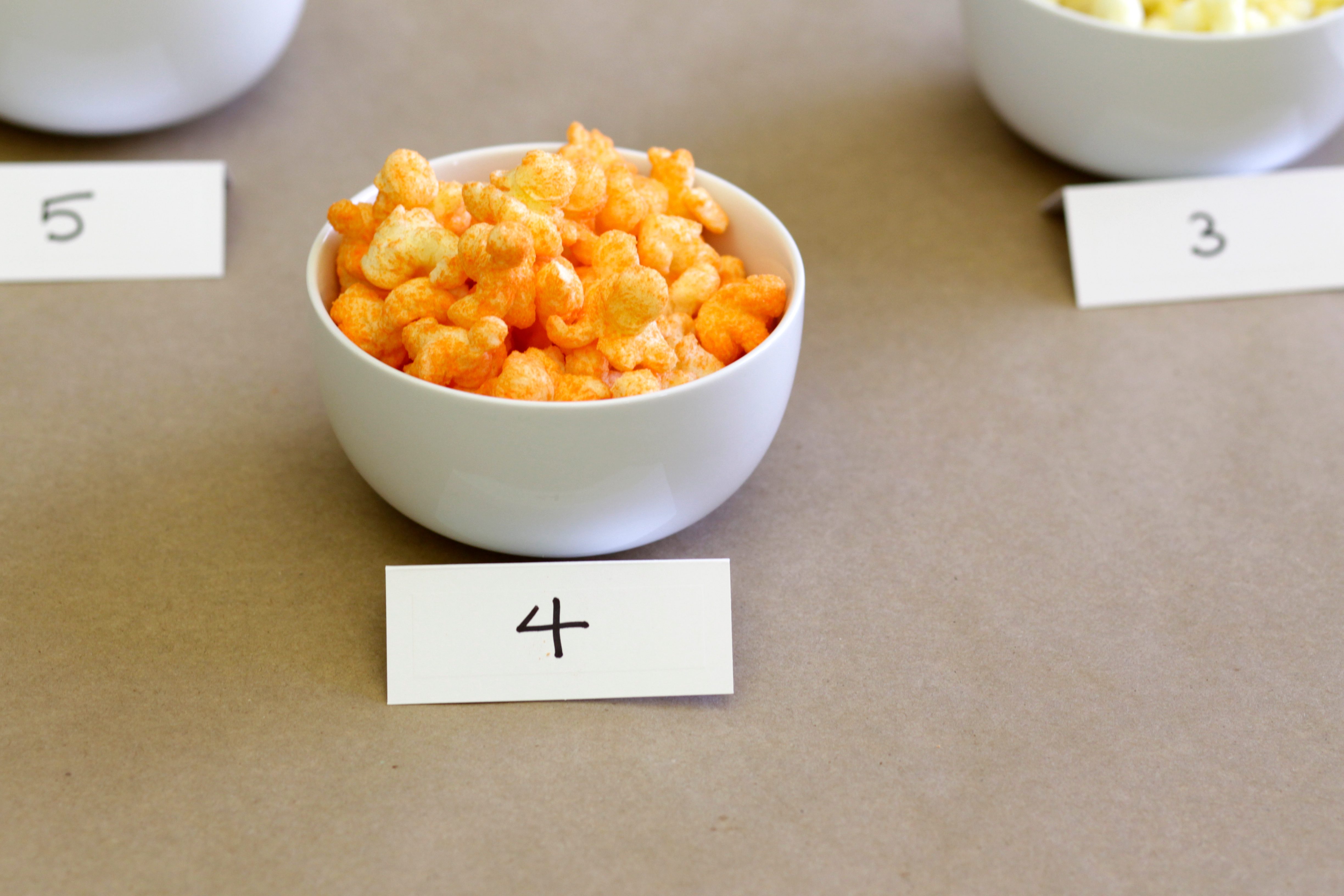 Bowl with the number 4 filled with cheese puffs