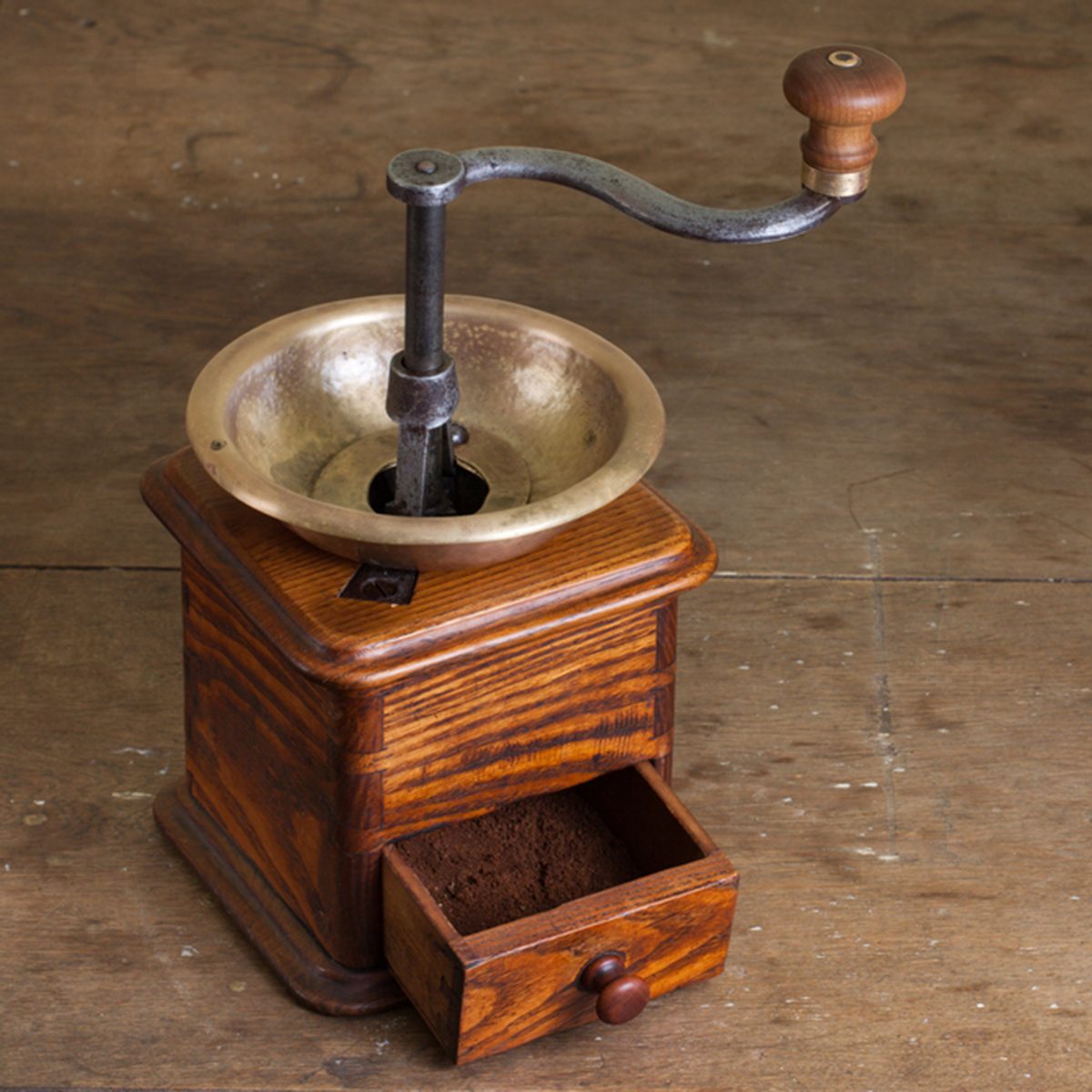 Vintage coffee grinder on old wooden table. Antique, XIX century; Shutterstock ID 103538423