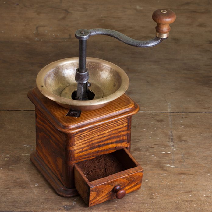 Vintage coffee grinder on old wooden table. Antique, XIX century; Shutterstock ID 103538423