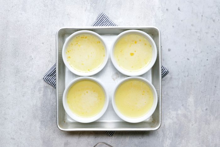 Arrange the cups in two 8x8-inch baking pans