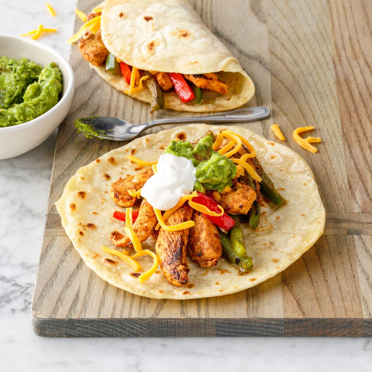 Chicken Fajitas Served on Tortilla on Chopping Board
