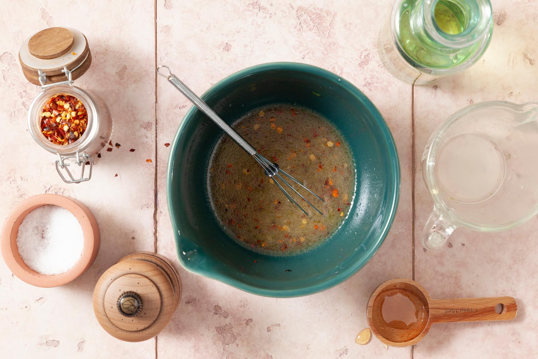 A Fresh Salad Dressing Bowl With a Whisk in It