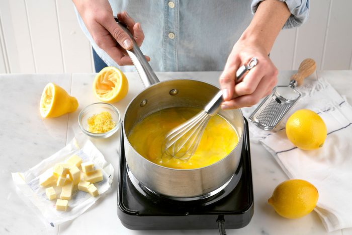A Person Stirring a Saucepan With a Whisk