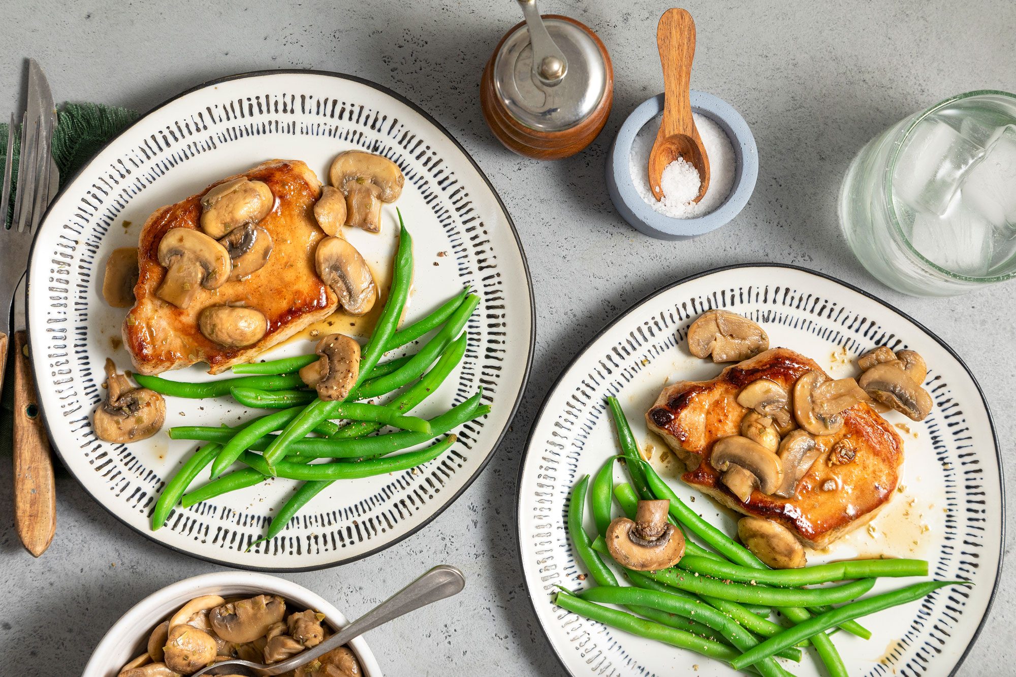 Mushroom Pork Chops Served in Fancy Ceramic Plates