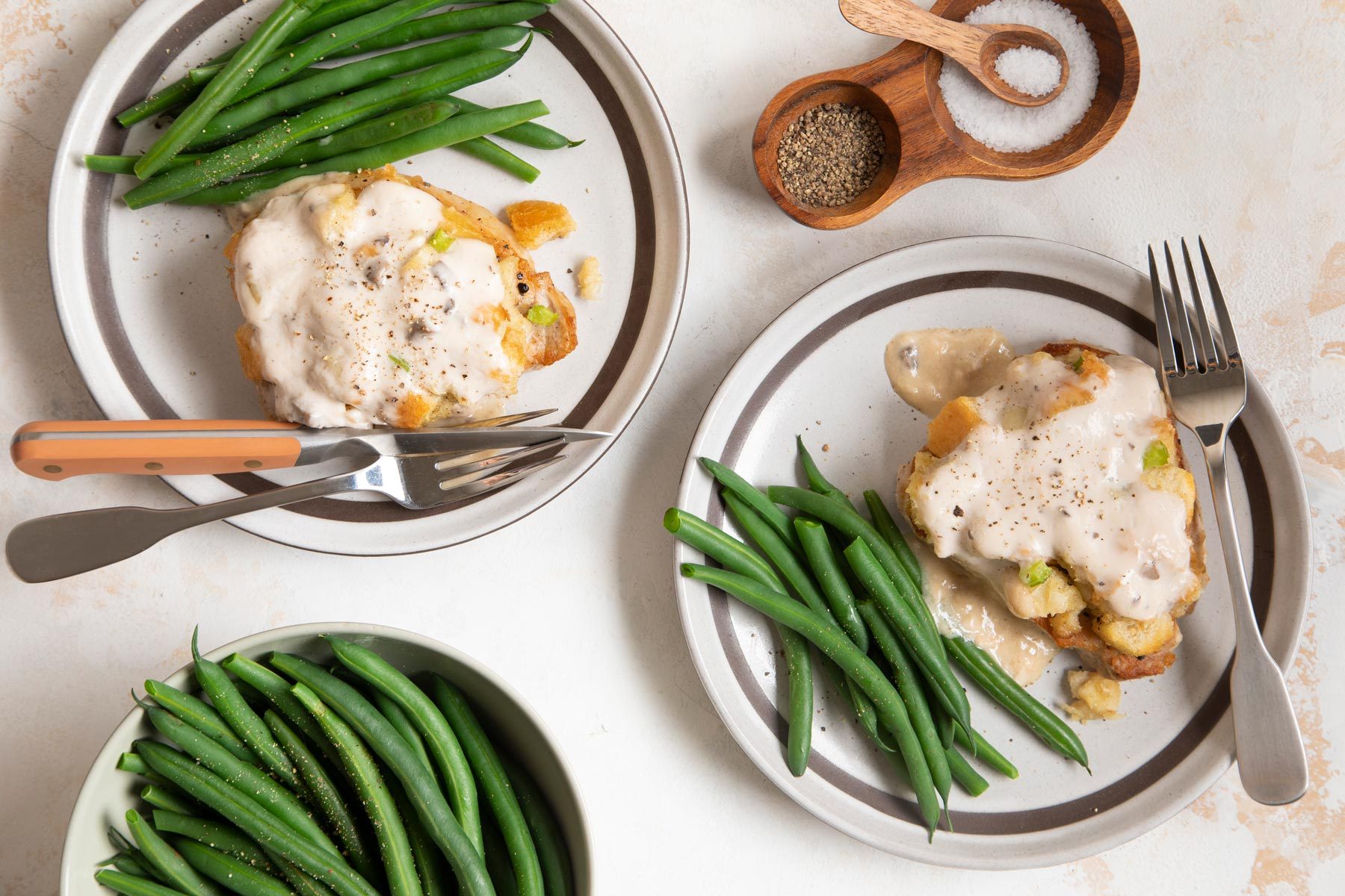 Two Plates of Pork Chops With Green Beans