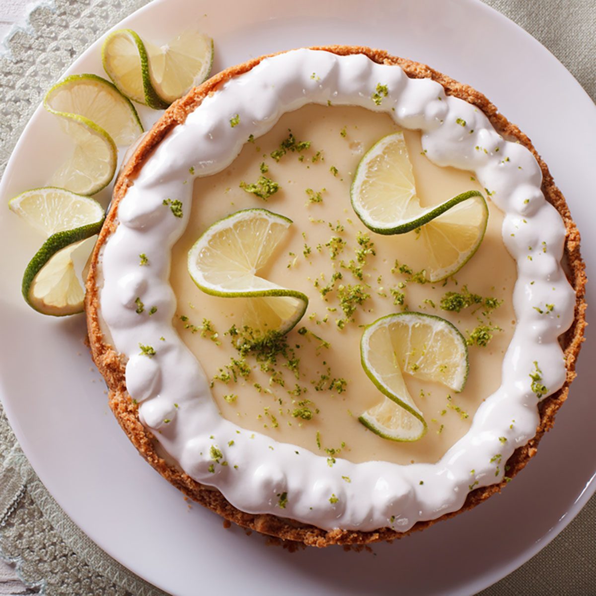 key lime pie with whipped cream close-up on the table. horizontal view from above