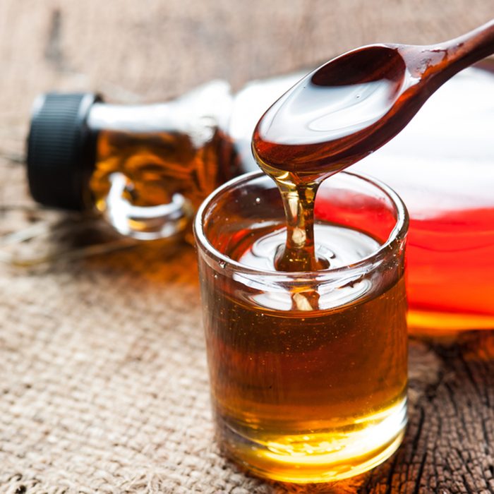 maple syrup in glass bottle on wooden table