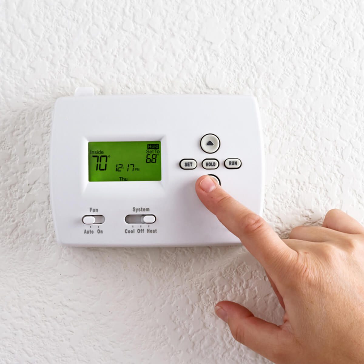 digital thermostat with finger pressing button