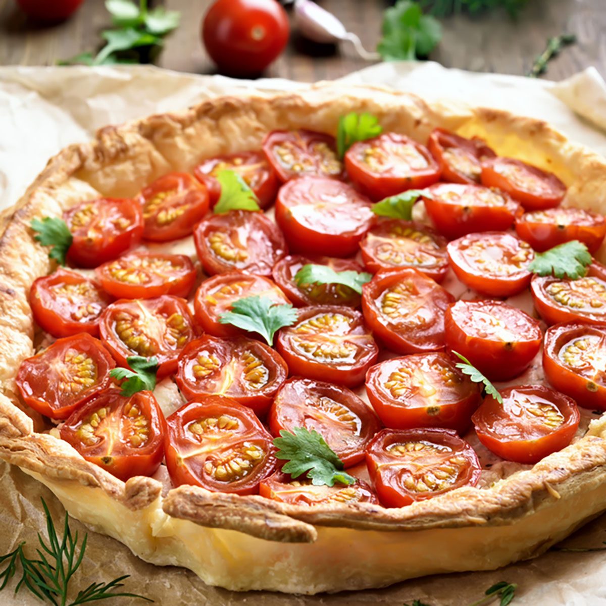 Tomato pie on baking paper, close up view