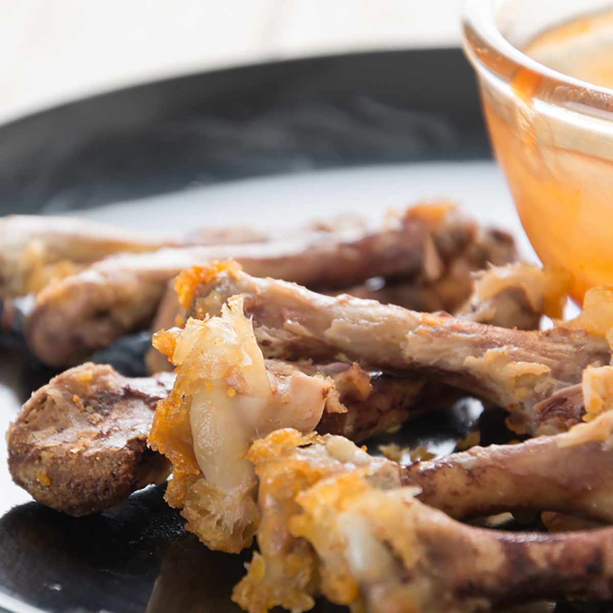 chicken bone on black plate