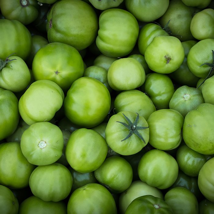 Pile of raw natural green tomatoes