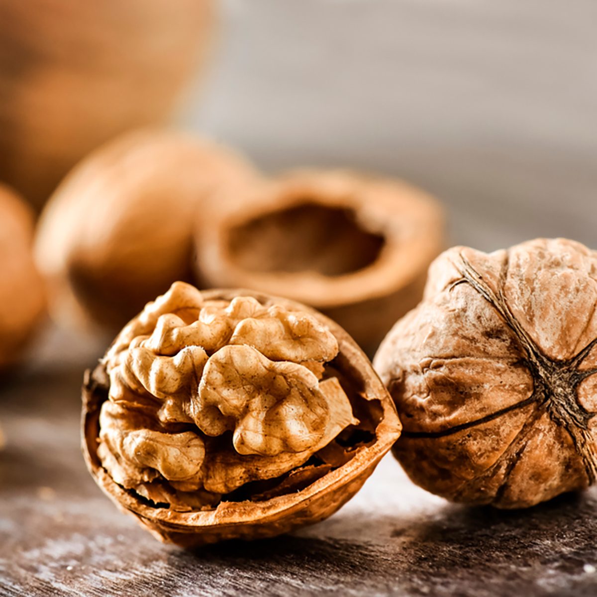 Walnuts kernels on dark desk with color background, Whole walnut in wood vintage bowl