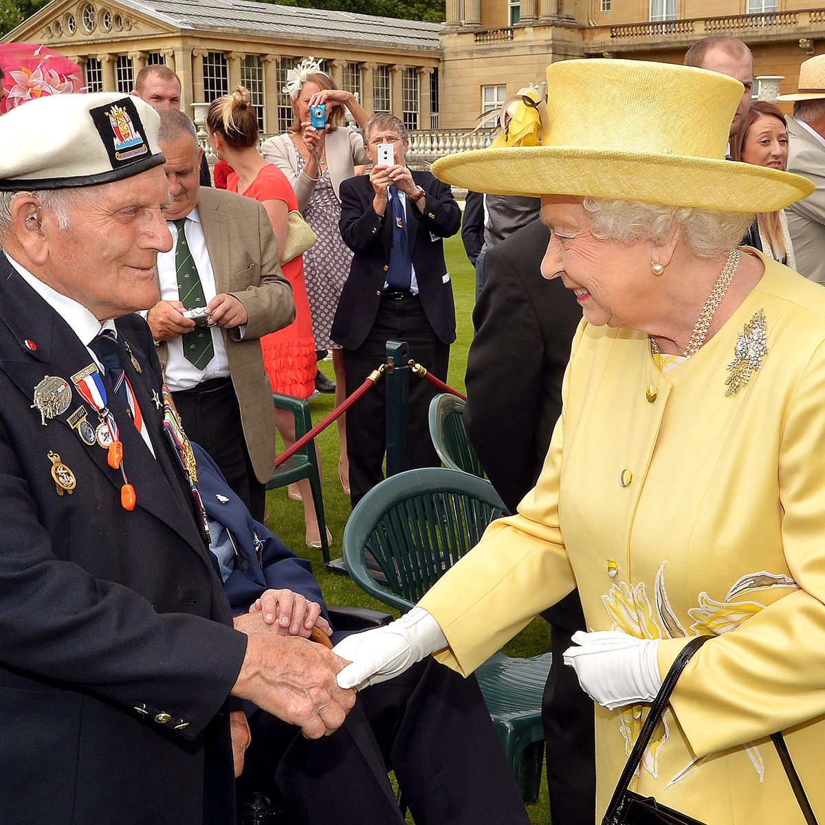 Queen Elizabeth II talks to a veteran Not Forgotten garden party at Buckingham Palace, London, Britain
