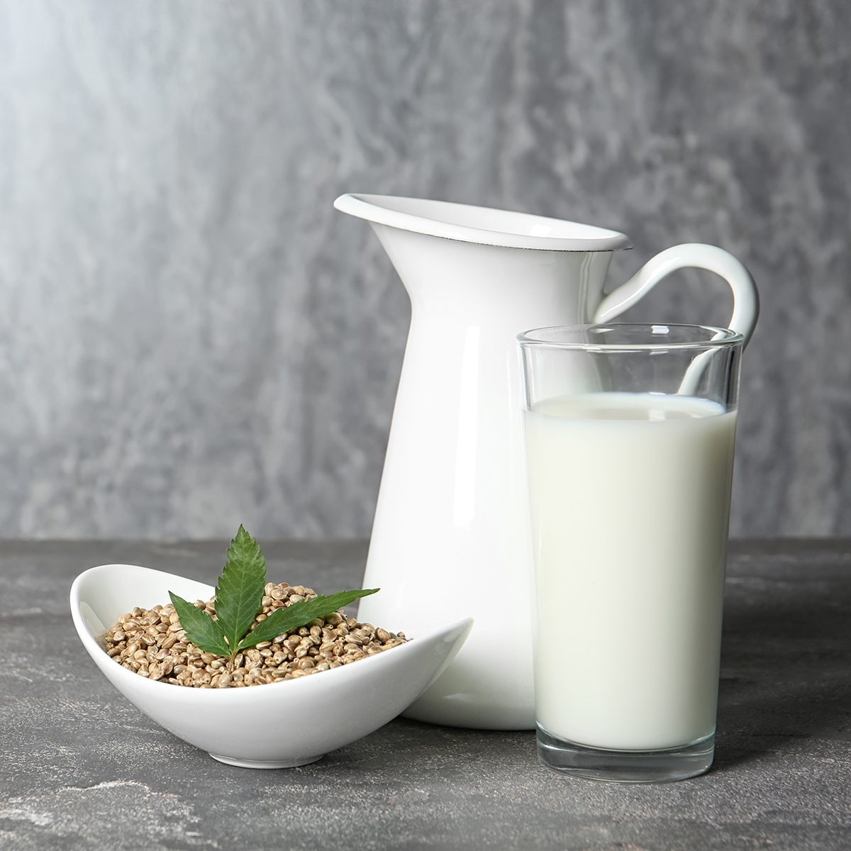 Composition with hemp milk and space for text on grey background