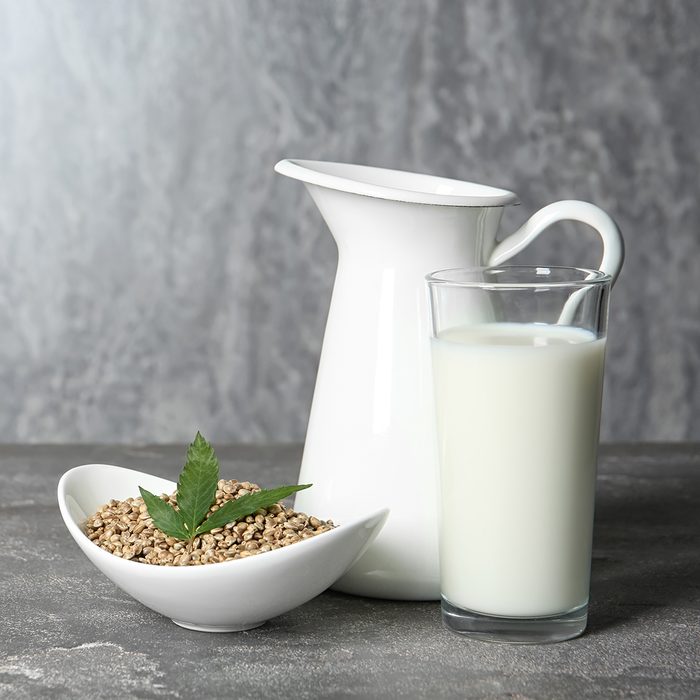 Composition with hemp milk and space for text on grey background