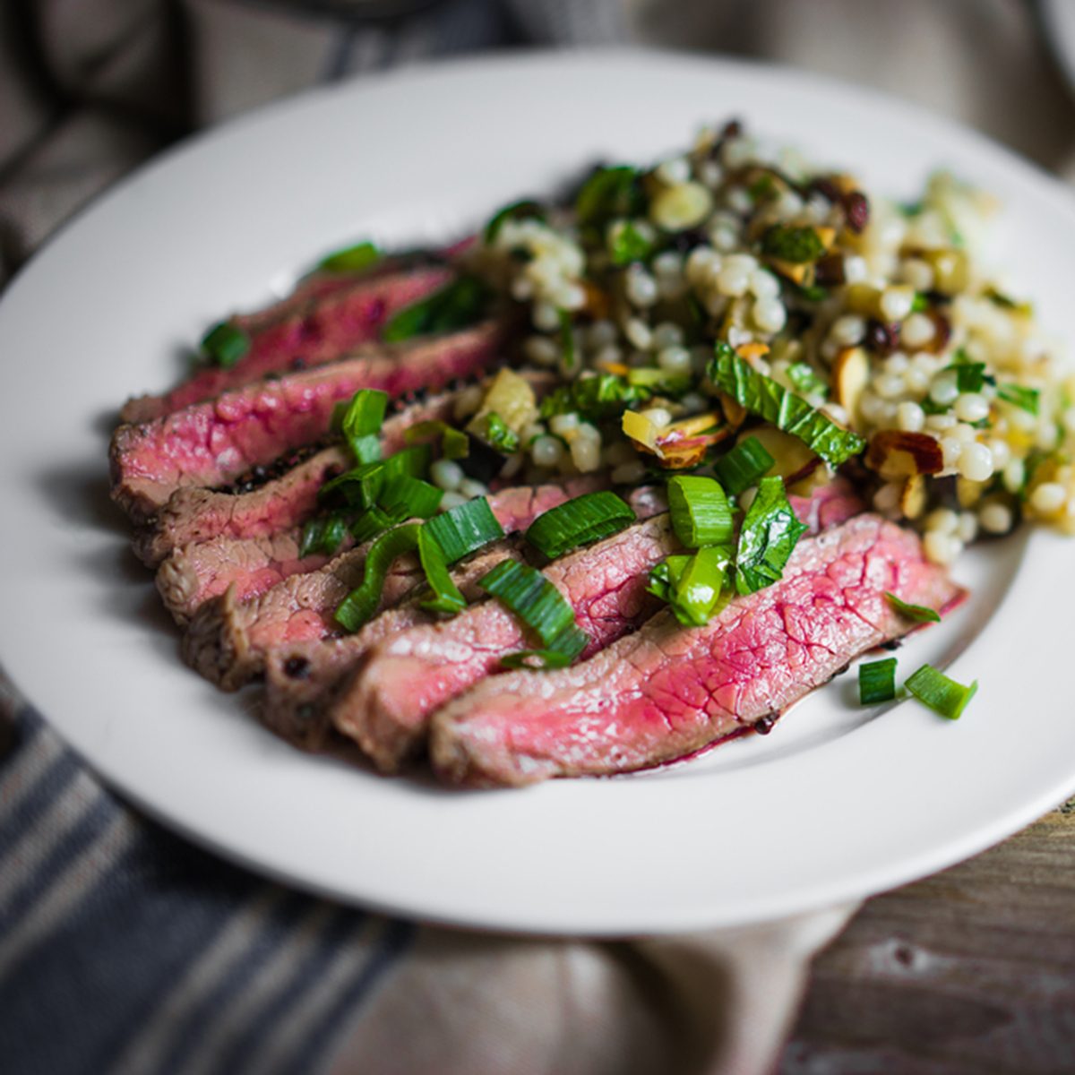 Sliced steak with couscous and vegetables