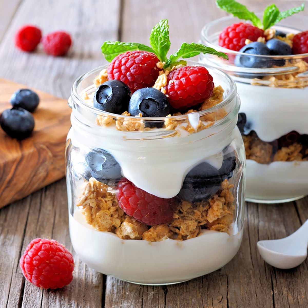 Blueberry and raspberry parfaits in mason jars,