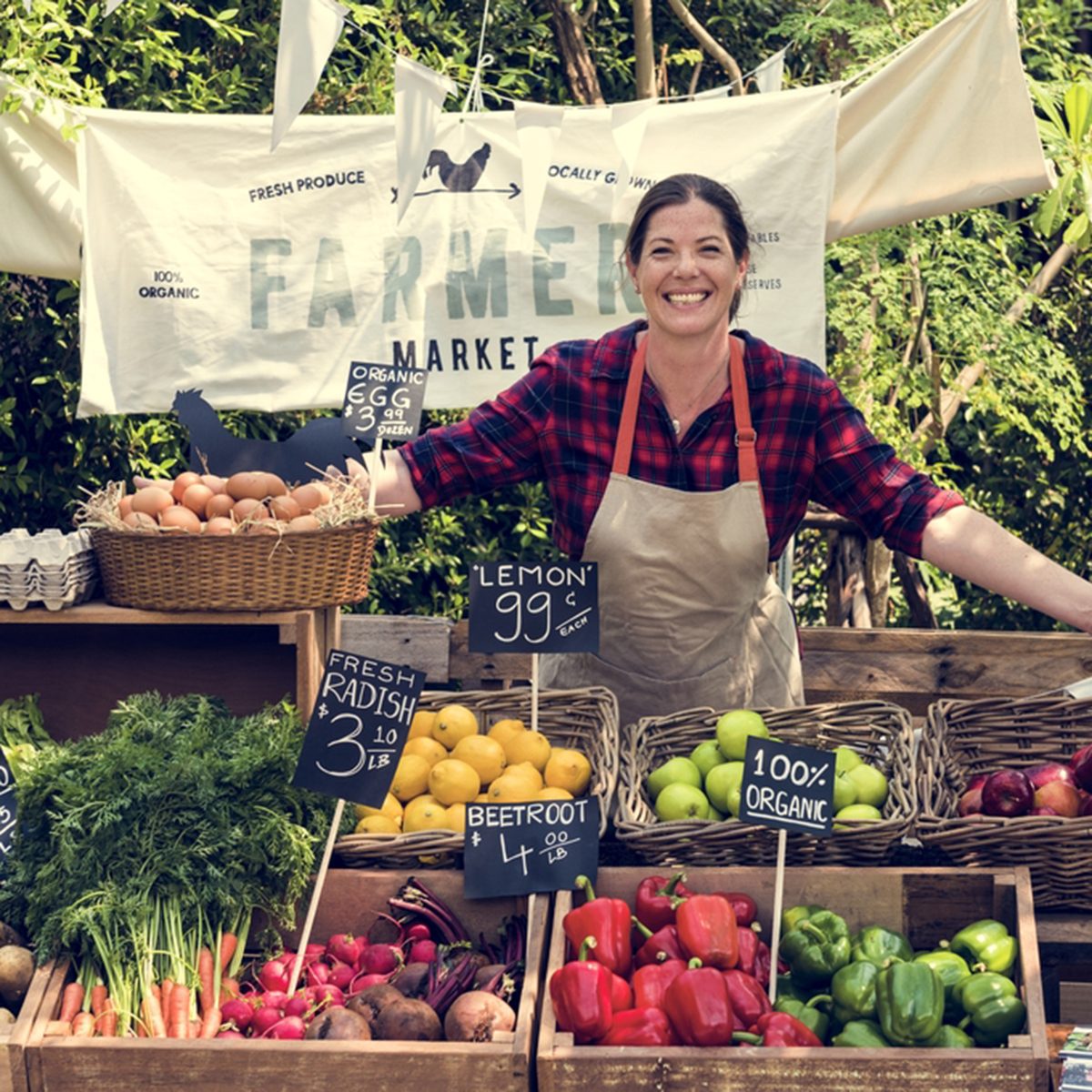 Greengrocer selling organic fresh agricultural product at farmer market