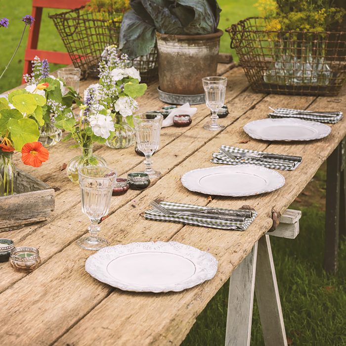 Wooden table setup for garden party or dinner reception.