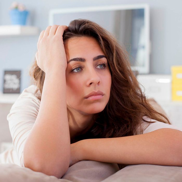Woman holding her head in pain