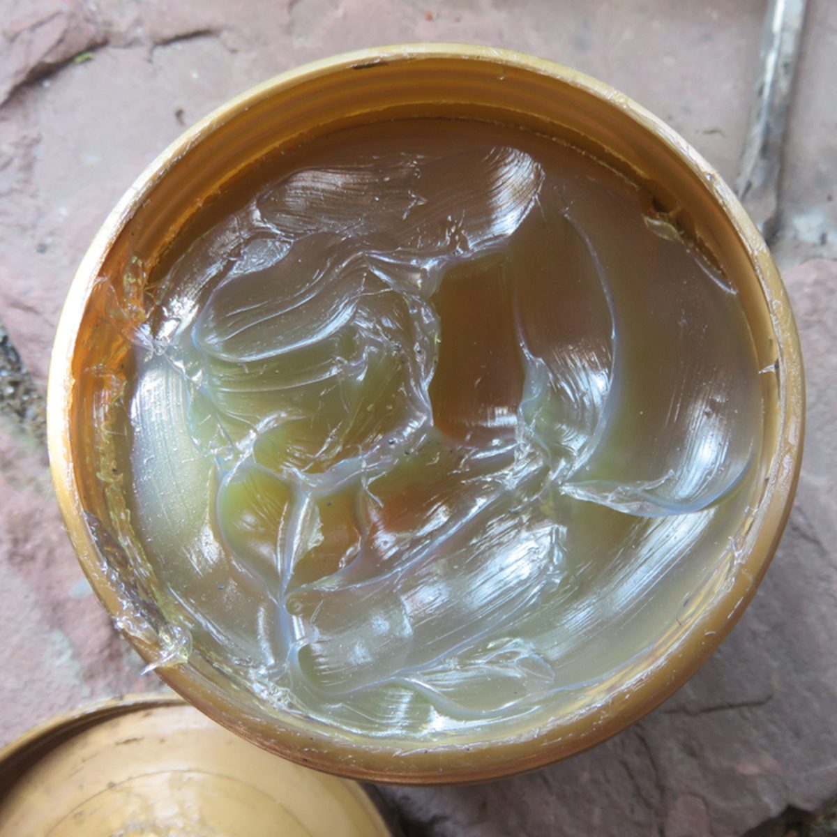 Grease or semisolid lubricant in a plastic container