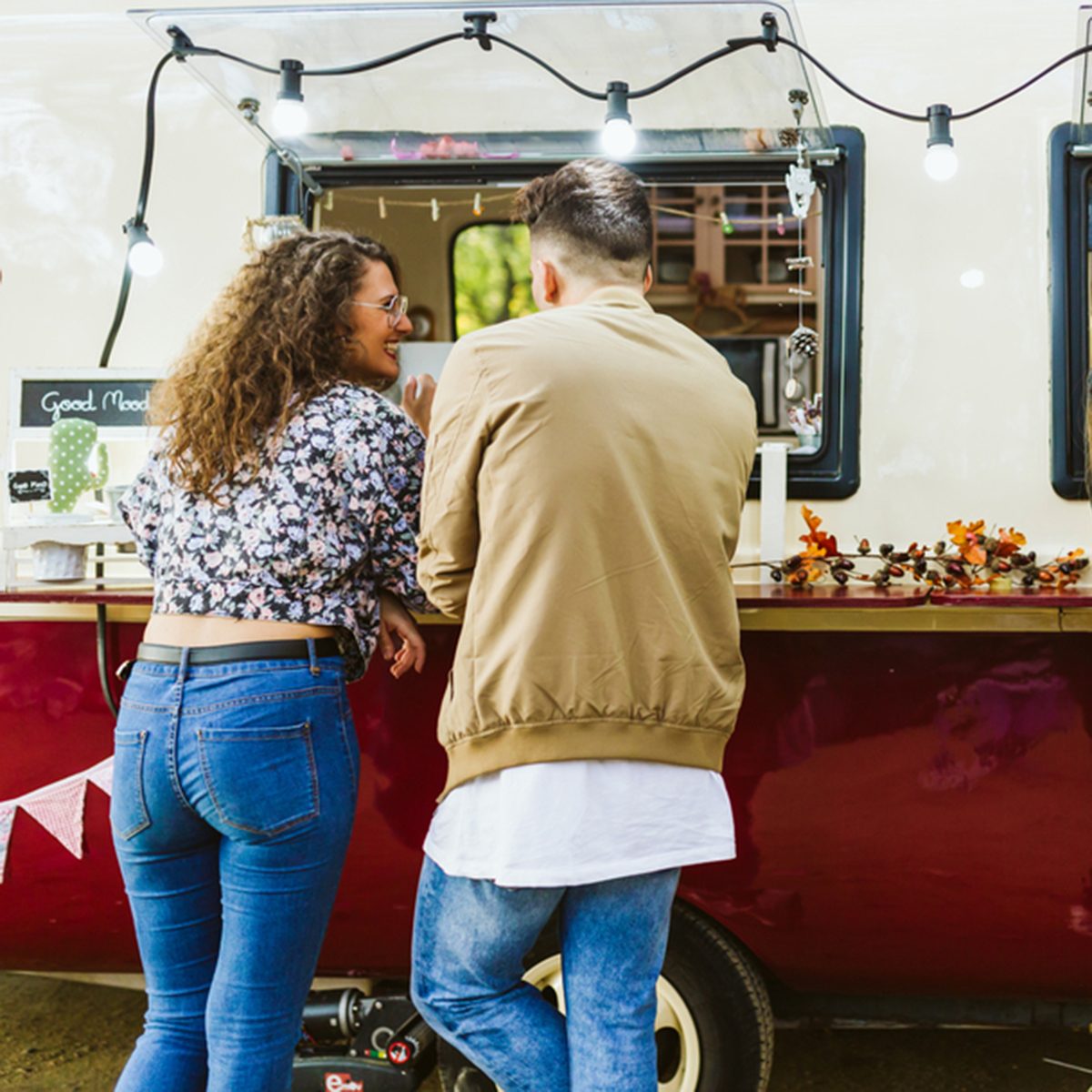 Portrait of group of friends visiting eat market in the street.