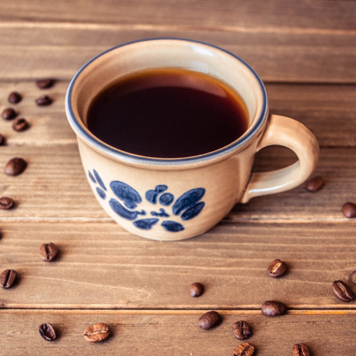 A cup of coffee and coffee beans