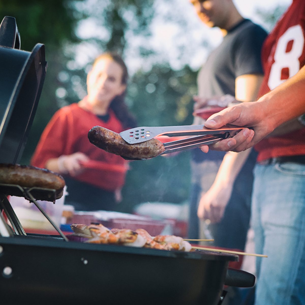 Tailgate: Man Works The Grill At Tailgating Party