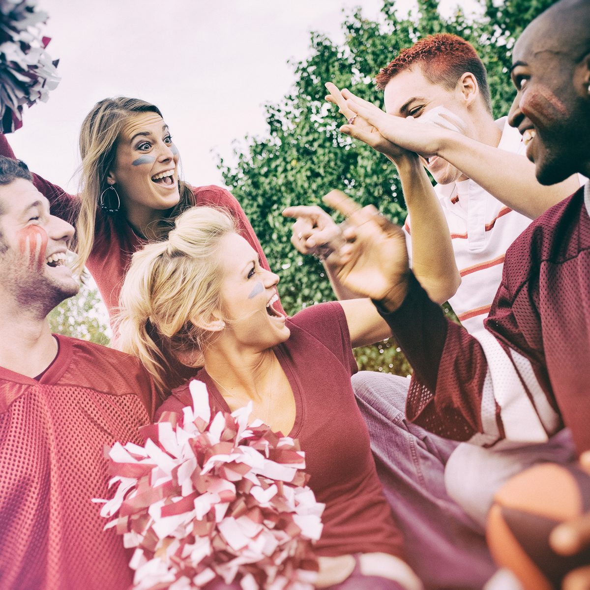 Tailgating: College Student Fans Give High Five For Team Win
