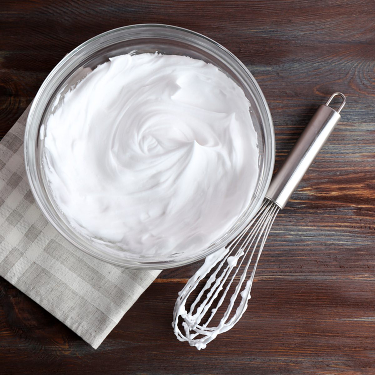 Whipped egg whites for cream on wooden table