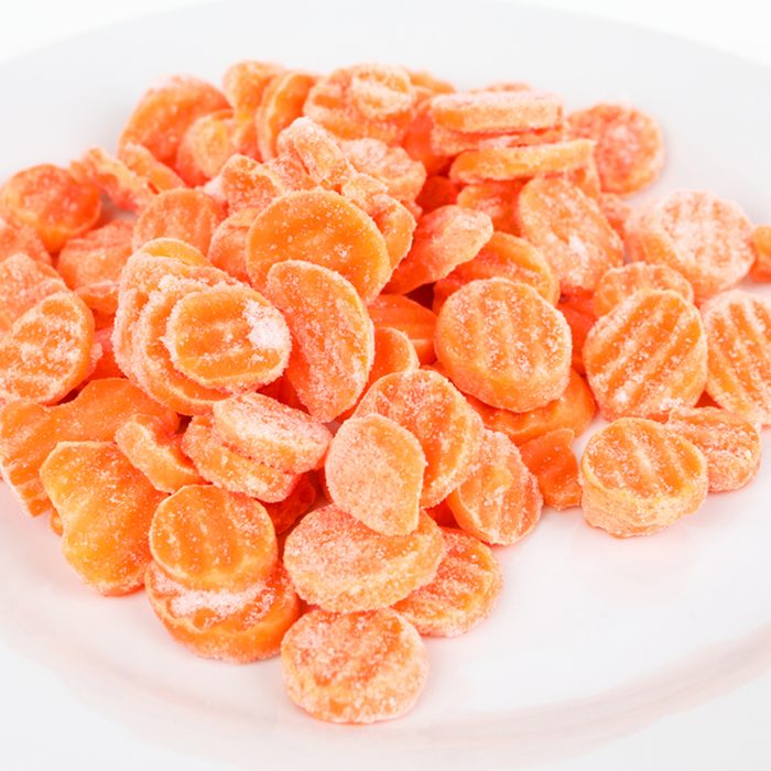 Frozen carrots on a plate with white background