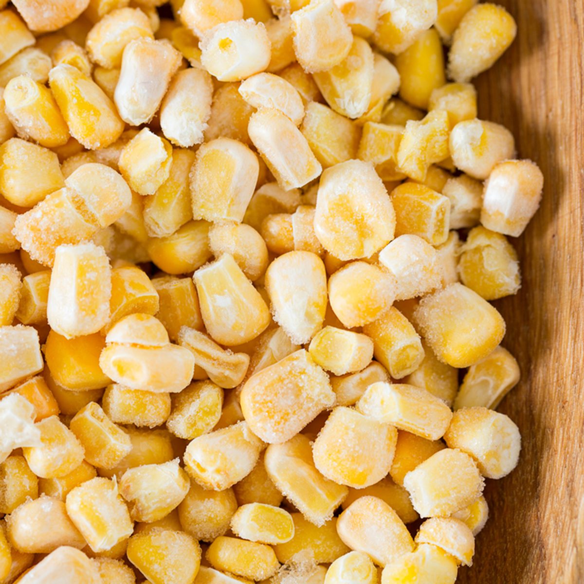 frozen sweet corn on woode surface