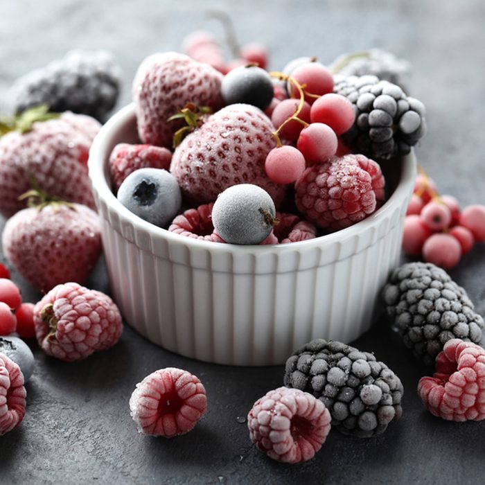 Frozen berries on a black wooden table