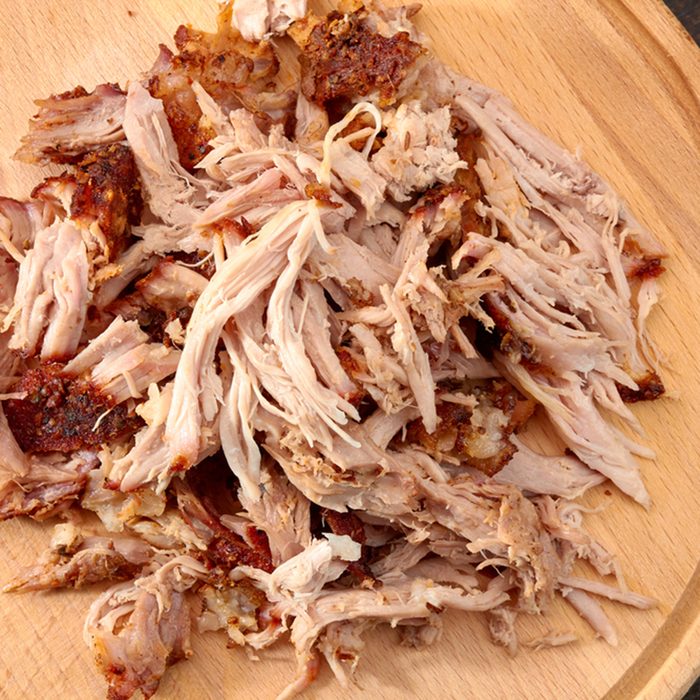 Pulled pork on round wooden board