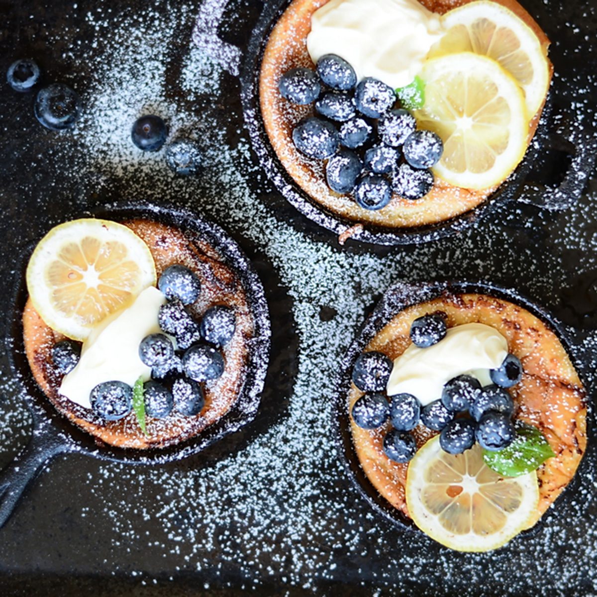 Mini Dutch Baby pancakes with fresh blueberries and Mascarpone Cream