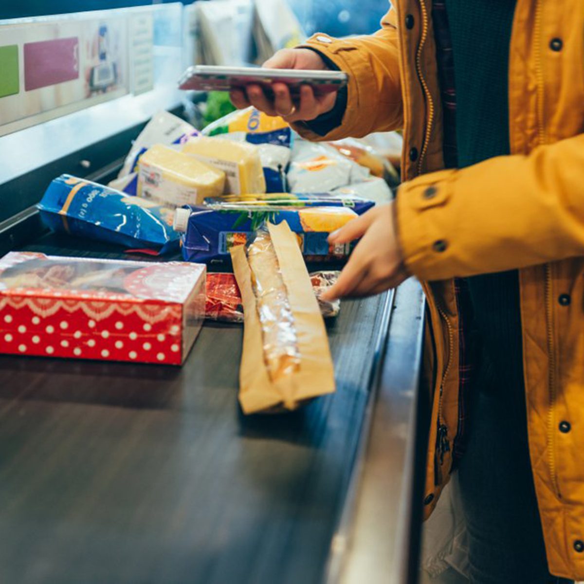 Check-out conveyor belt full of food 