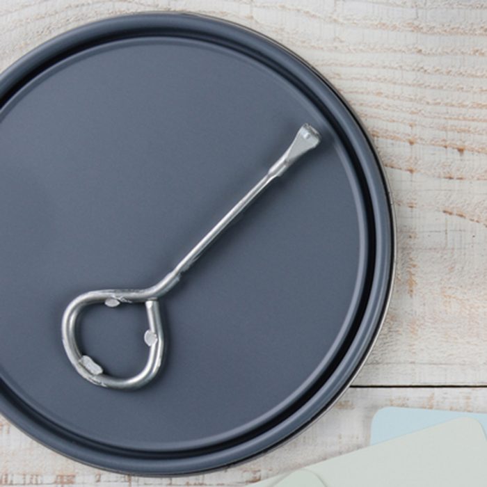 Overhead shot of a paint can lid, opener, color samples and paint brush on a rustic wooden surface. Horizontal format with copy space. ; Shutterstock ID 242845189; Job (TFH, TOH, RD, BNB, CWM, CM): TOH