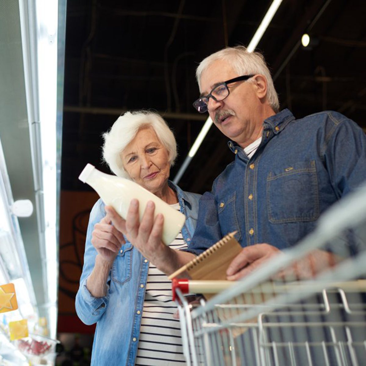 Reading the label on a jug of milk at the grocery store