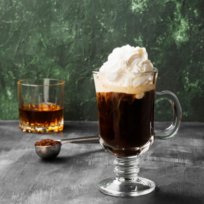 Irish coffee with whisky on dark background