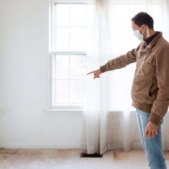 Man pointing at window