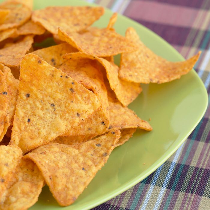 Heap of nachos on green plate.; Shutterstock ID 142006165; Job (TFH, TOH, RD, BNB, CWM, CM): TOH
