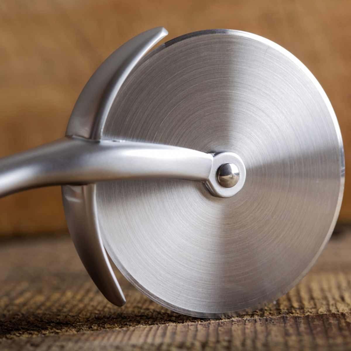 Circular Pizza Cutter on wooden rustic background; Shutterstock ID 441796336