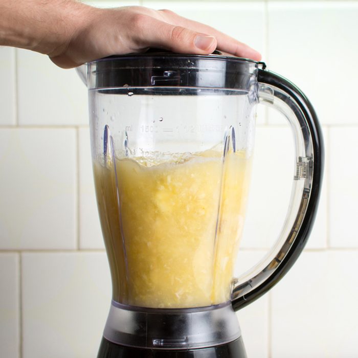 Using blender for making a healthy smoothie; Shutterstock ID 587714921