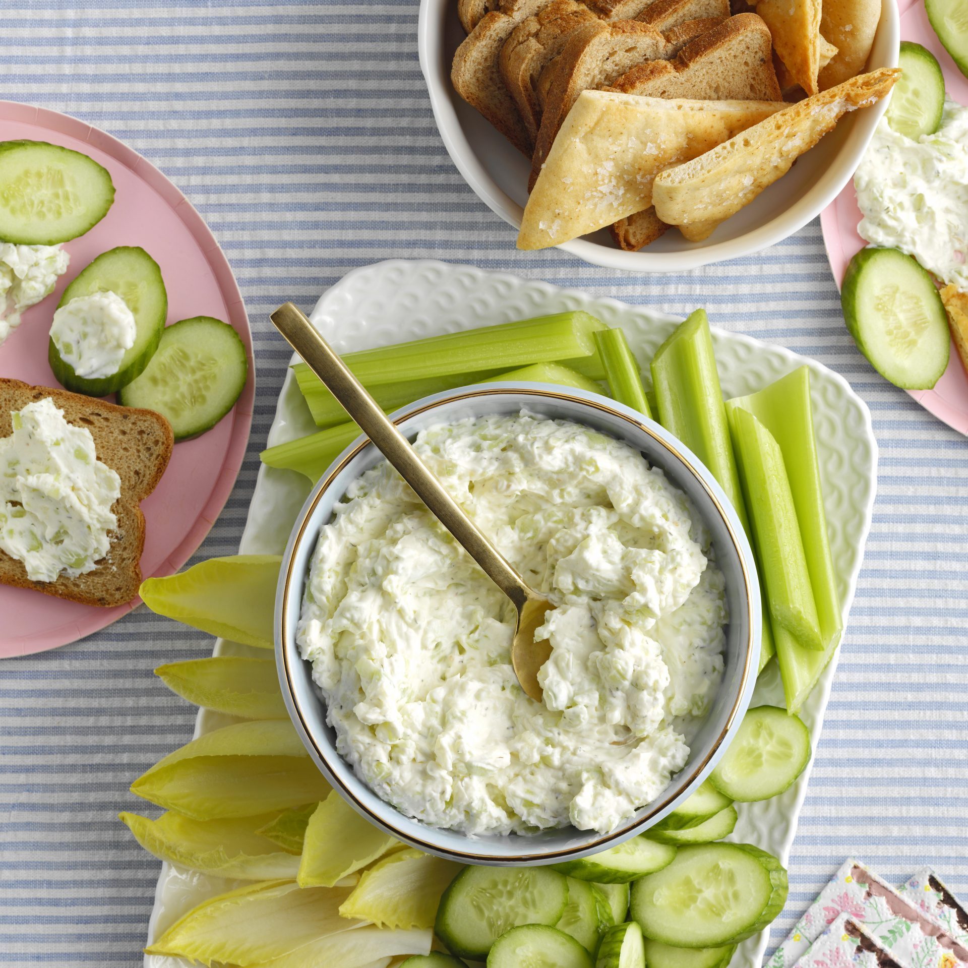 A Bowl of Benedictine Spread on a Ceramic Tray with Green Salad and Breads