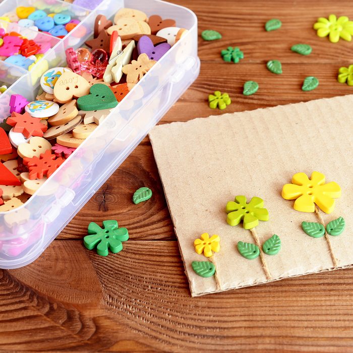 Summer card with yellow and green flowers. Postcard made of cardboard, buttons and cord.