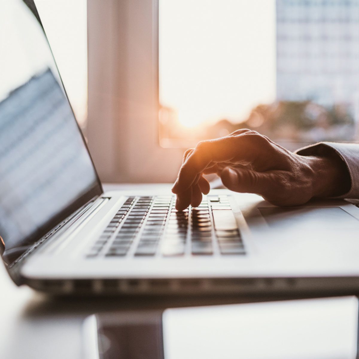 Man typing on computer keyboard.