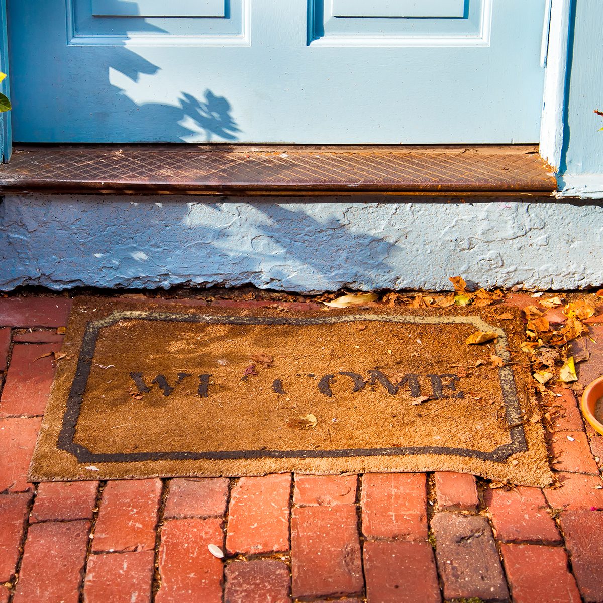 Welcome mat outside a cottage front door. ; Shutterstock ID 192399047; Job (TFH, TOH, RD, BNB, CWM, CM): TOH