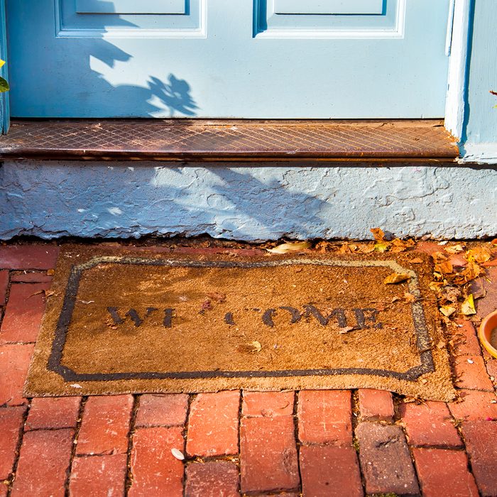 Welcome mat outside a cottage front door. ; Shutterstock ID 192399047; Job (TFH, TOH, RD, BNB, CWM, CM): TOH