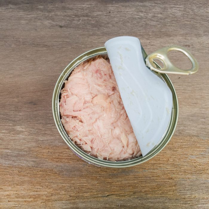 Tuna can on the old wood table background